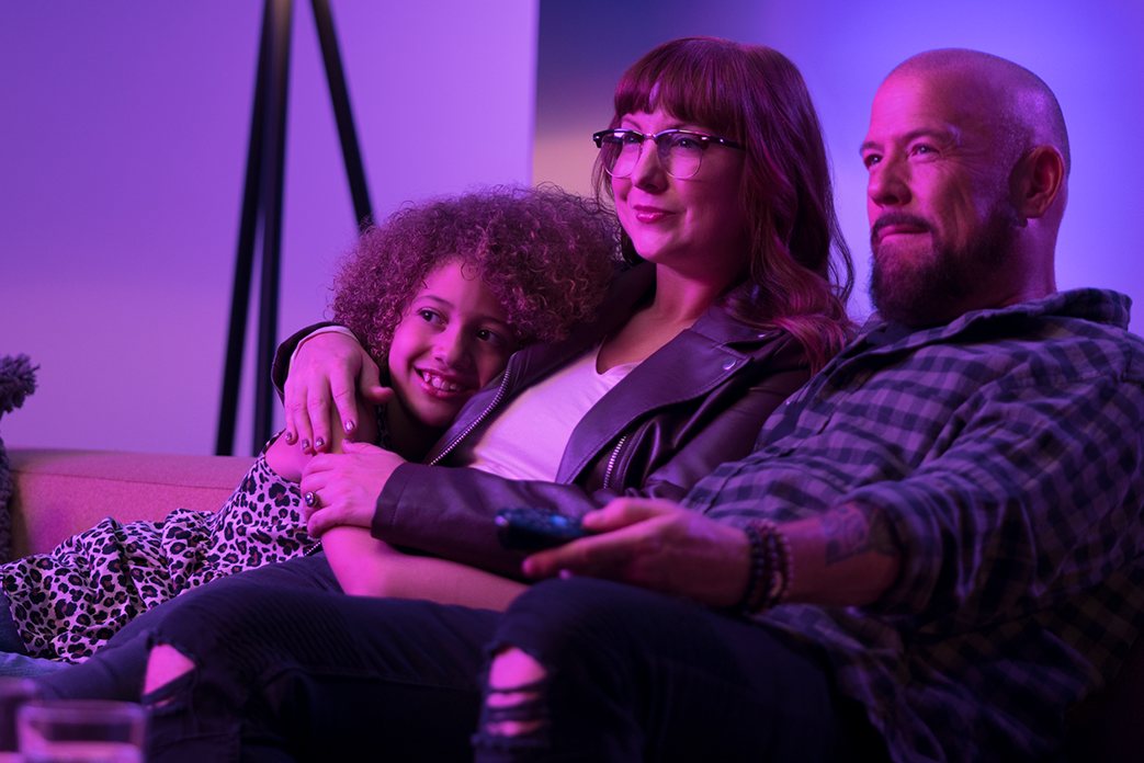 family sitting relax with remote in hand