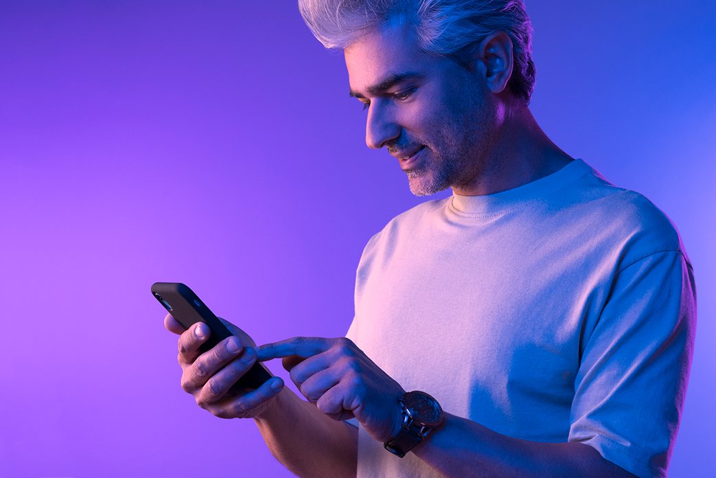 young man interacting with his phone