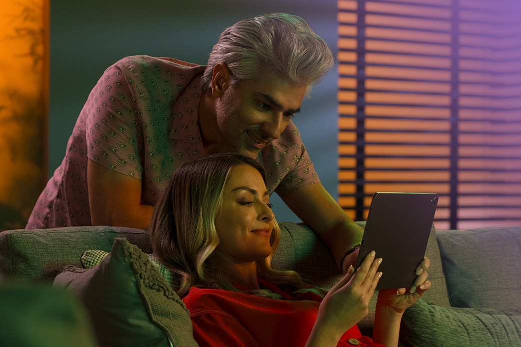 Image of a couple watching an ipad together